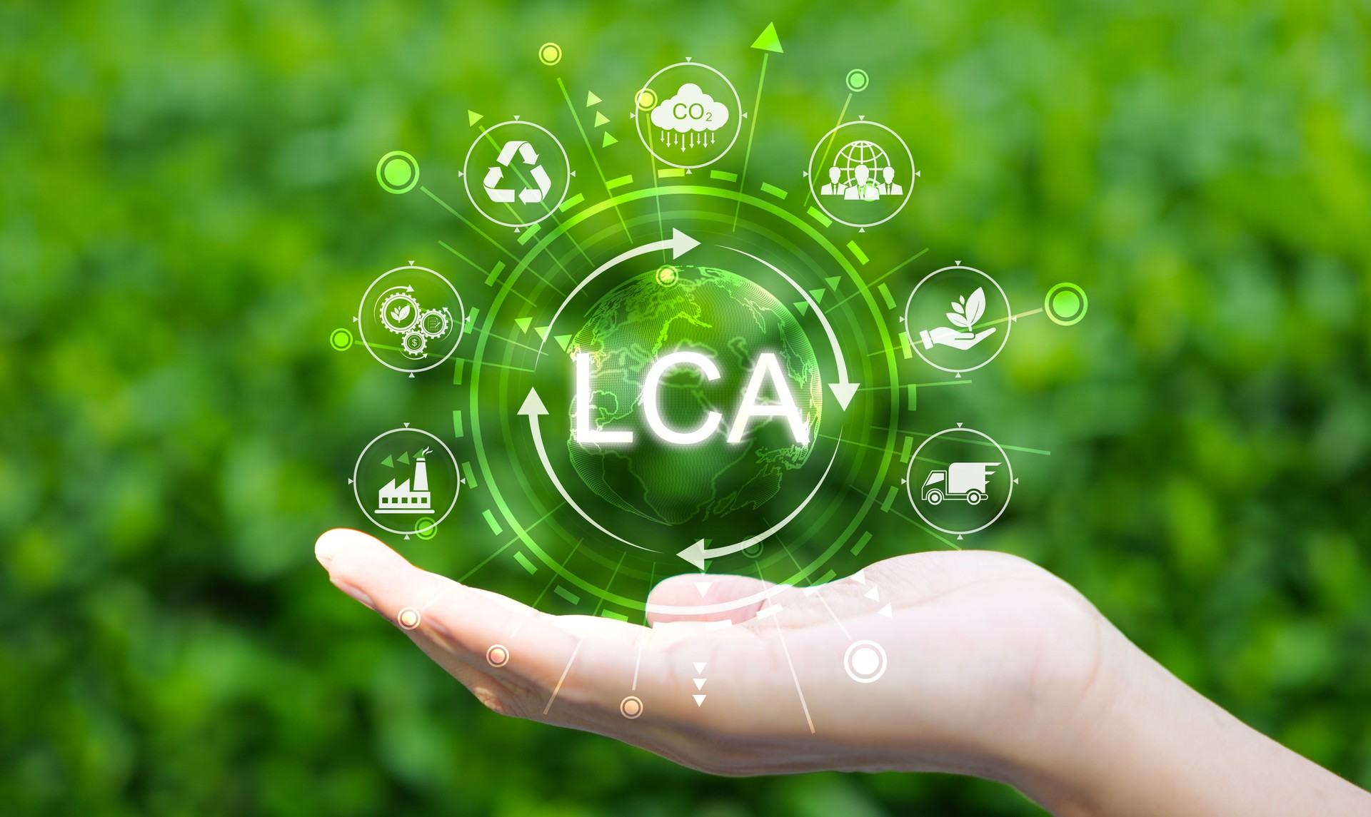 LCA Life cycle assessment concept. A hand holds glowing globe icons representing sustainability, recycling, environmental impact, symbolizing life cycle assessment (LCA) for eco friendly initiatives.